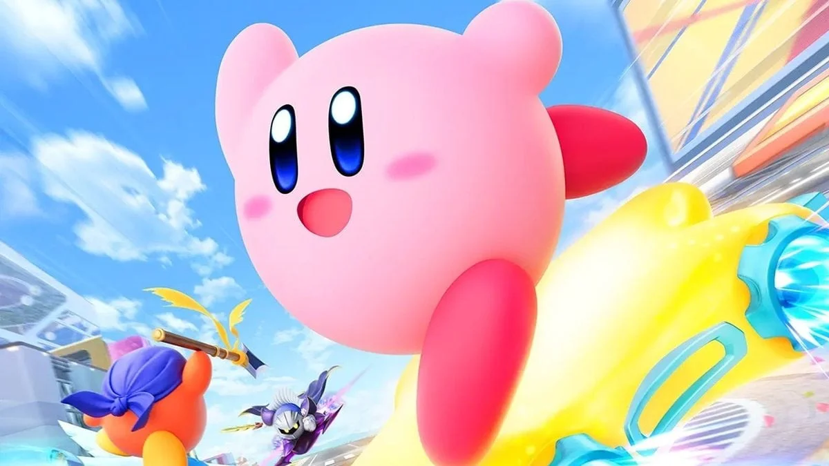 Kirby montado en un vehículo amarillo en una carrera con otros personajes.